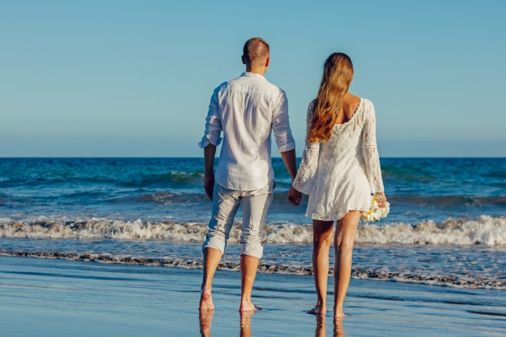 couple on beach holding hands