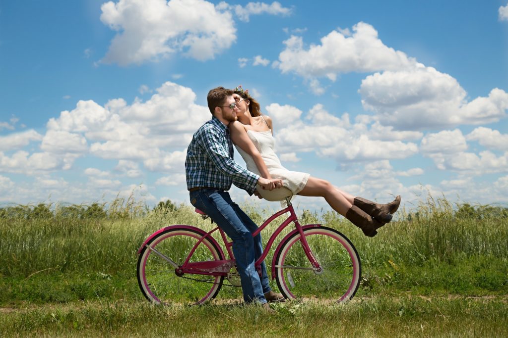 kissing couple on bicycle